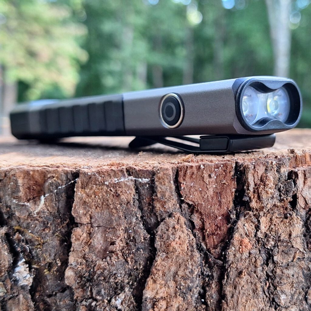 LP-EDC 5.0 Low Profile Thin Flashlight sitting on a tree stump