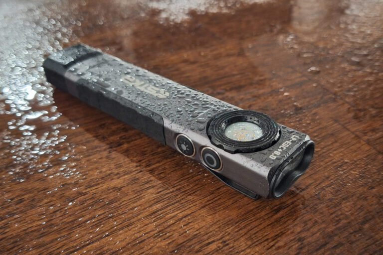 LP-EDC 5.0 low profile flat flashlight with water droplets on it